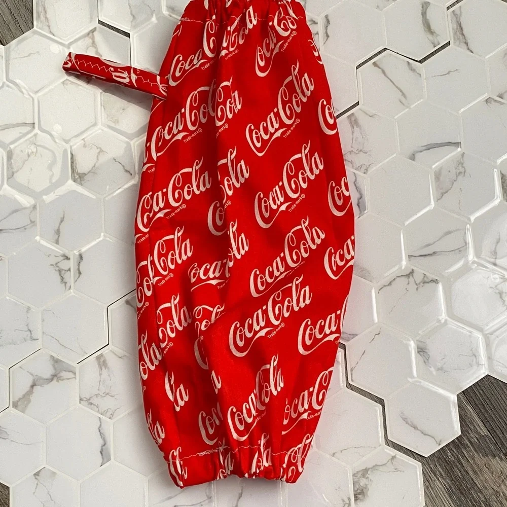 Handmade wall hanging grocery bags organizer and pantry with Coca Cola logo.
